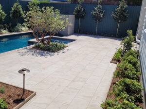 Newly installed planting and low-voltage landscape lighting beside the pool terrace at the Webster Street garden in 2023.