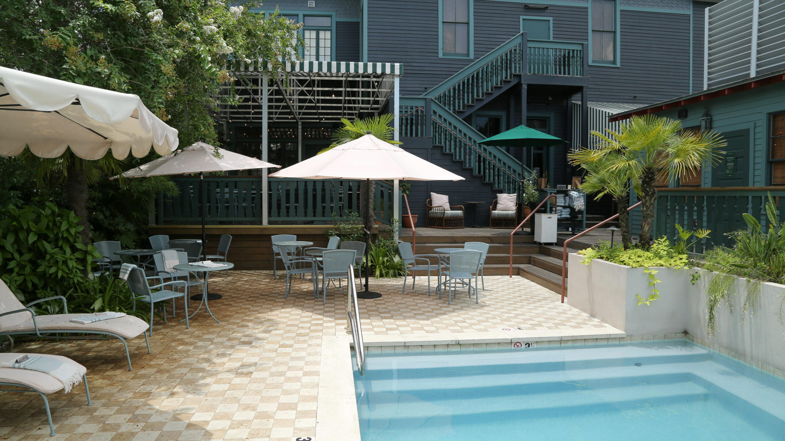 Swimming pool and shaded lounge terrace at The Chloe boutique hotel in Uptown New Orleans