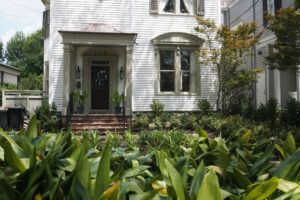 Front garden renovation with layered plantings framing a historic Uptown New Orleans home.